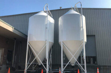 A front view of two, white RMS standard/general silos.