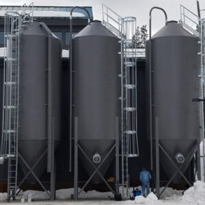 A front view of three, black RMS standard/general silos.