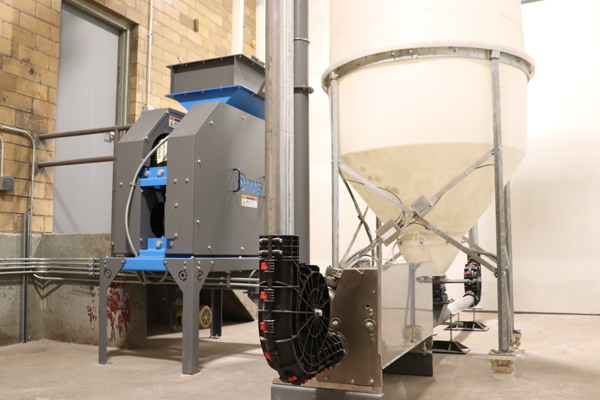 A 4 roll mill from RMS Roller-Grinder sits on a concrete floor.