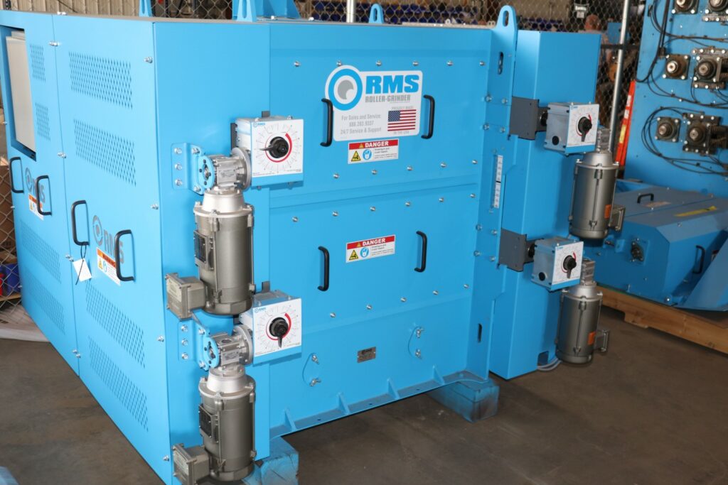 Photo of blue RMS mill with roll gap control in warehouse